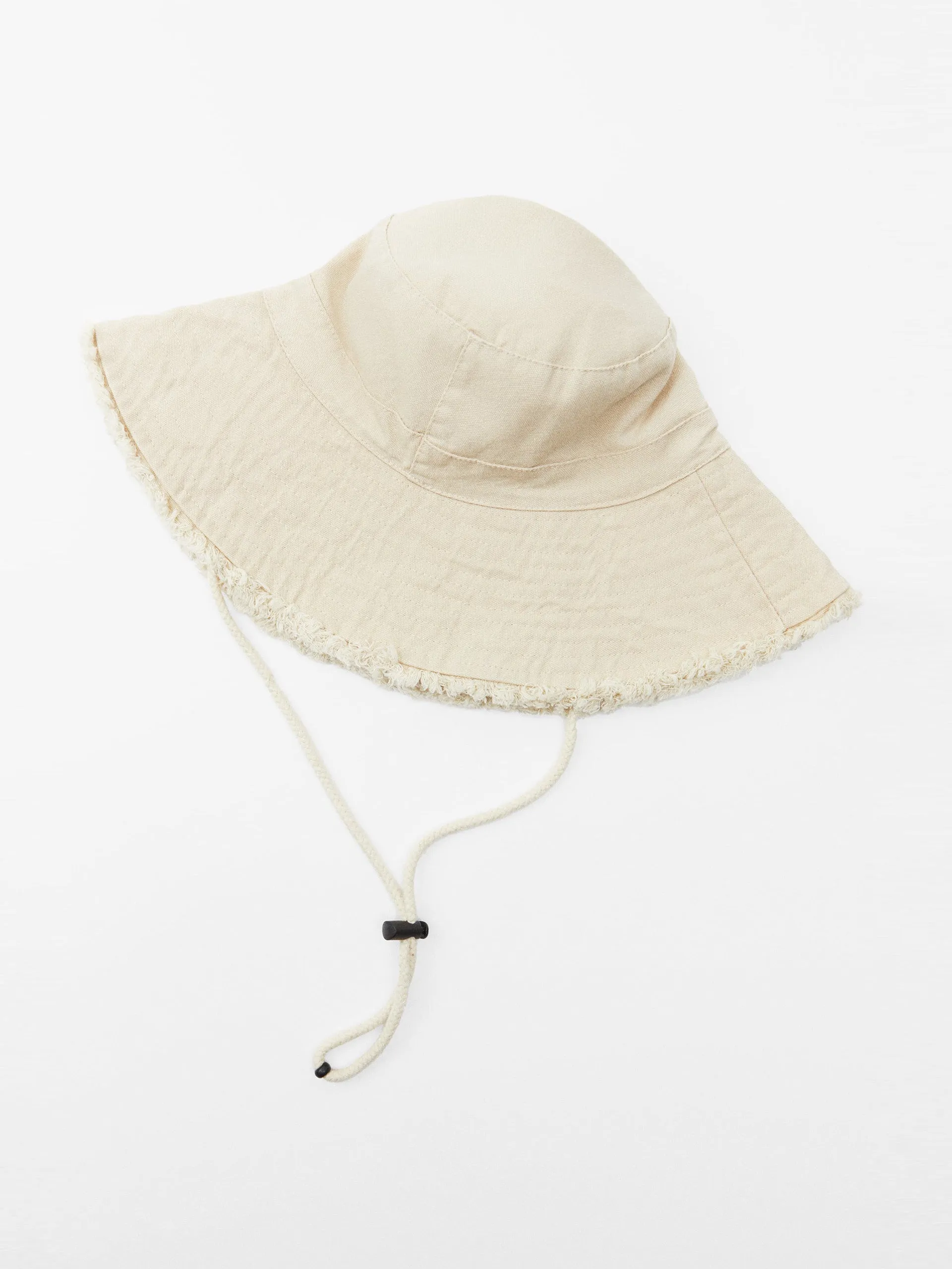 Ivory frayed bucket hat with drawstrings