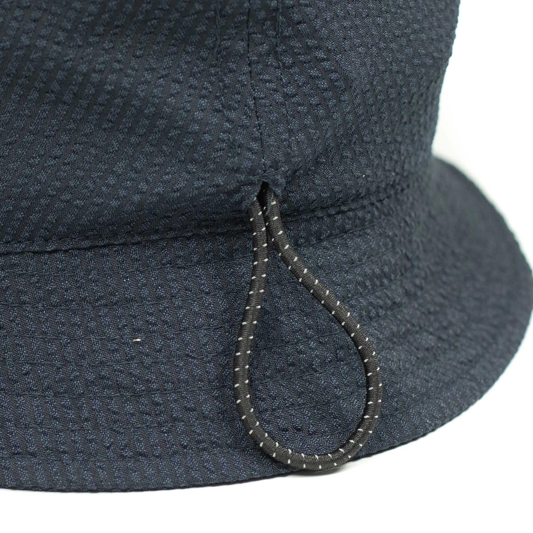 Storage loop bucket hat in tonal navy blue CoolMax seersucker